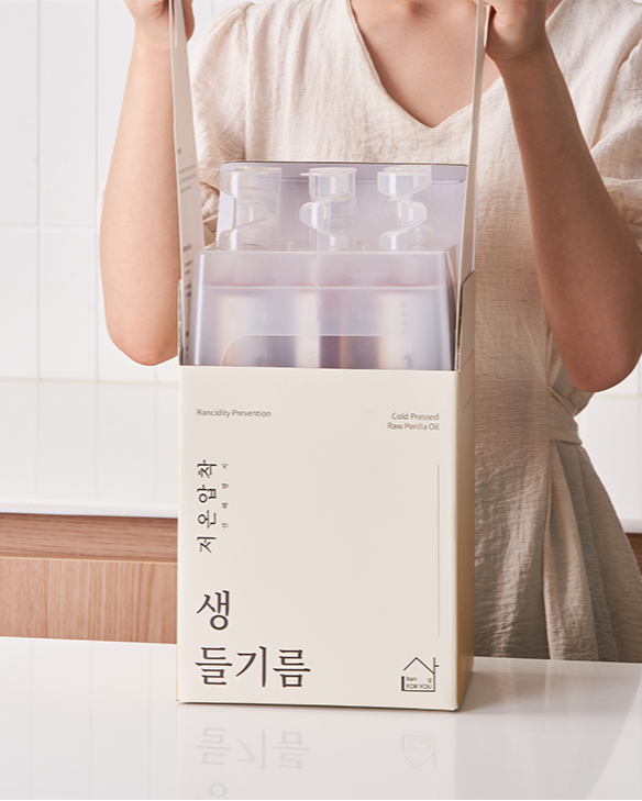 Person lifting Perilla Oil bottles out of box