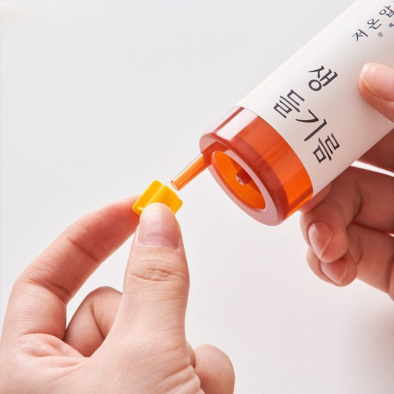 hand holding perilla oil syringe and cap